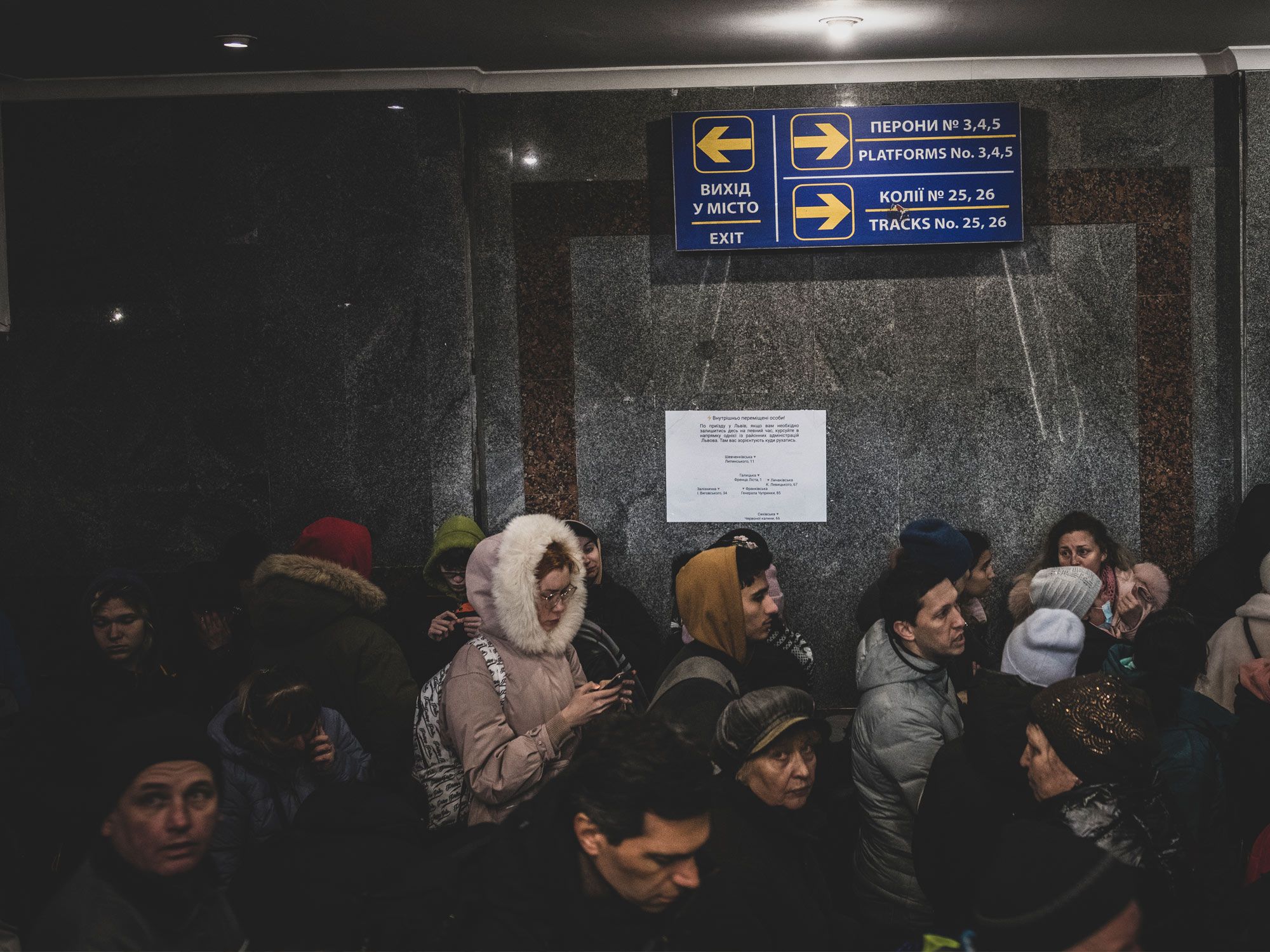 Lviv, Ukraine - March 3, 2022: A long line of people wait to board a train to Poland in Lviv, Ukraine.