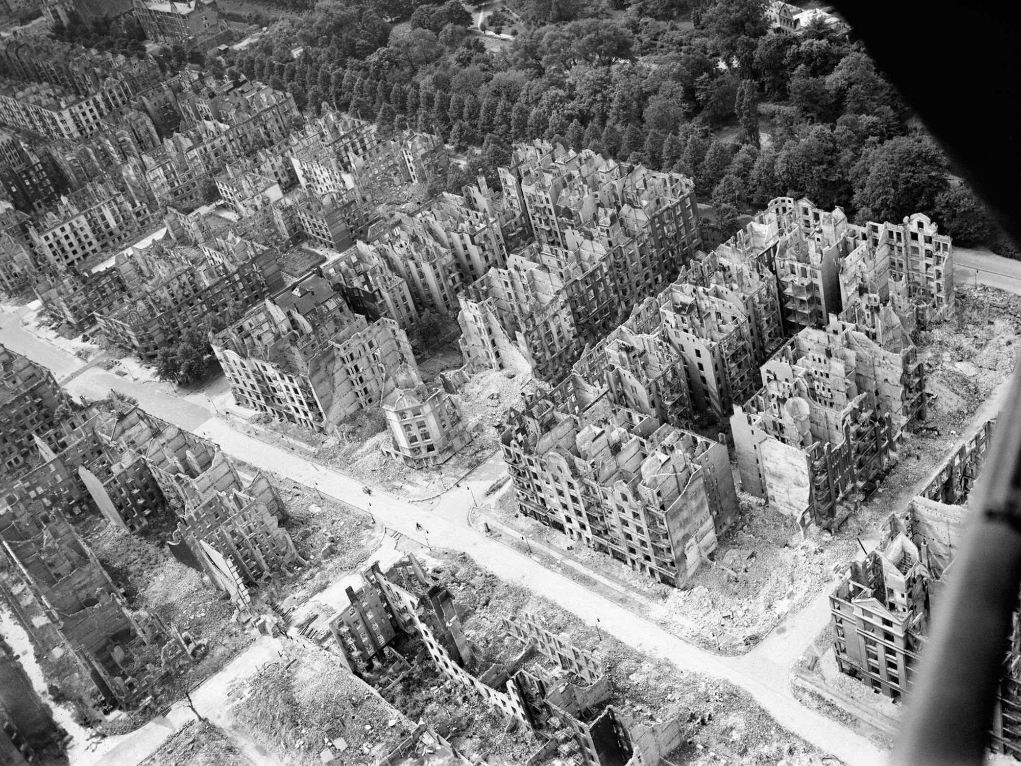 Oblique aerial view of ruined residential and commercial buildings south of the Eilbektal Park (seen at upper right) in the Eilbek district of Hamburg, Germany. These were among the 16,000 multi-storeyed apartment buildings destroyed by the firestorm which developed during the raid by Bomber Command on the night of 27/28 July 1943